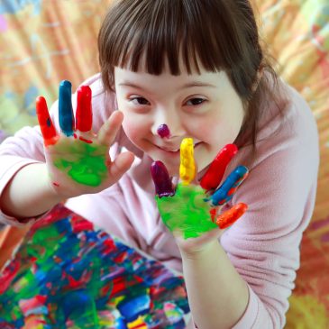 Cute little girl with painted hands